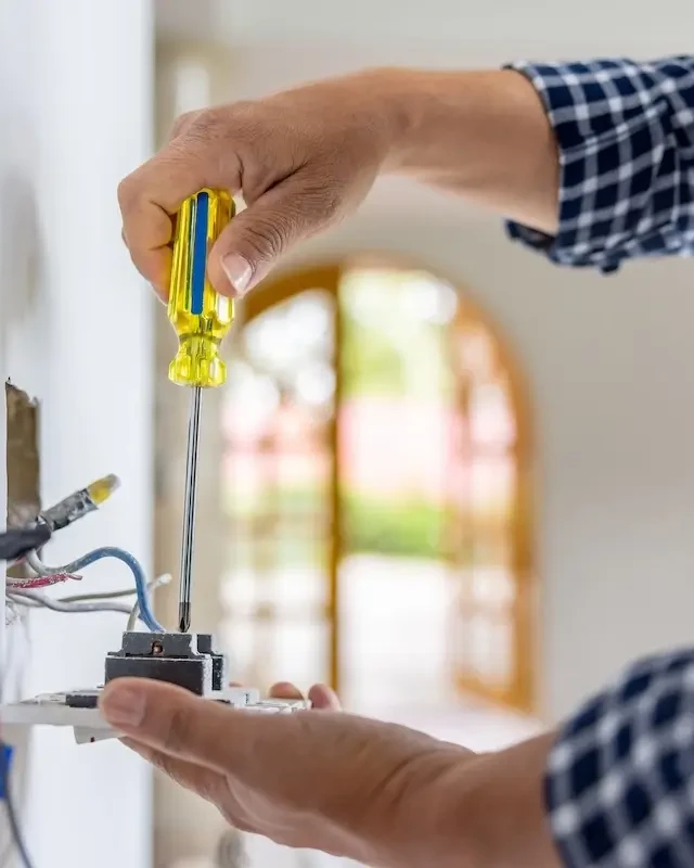 Tech repairing outlet indoors