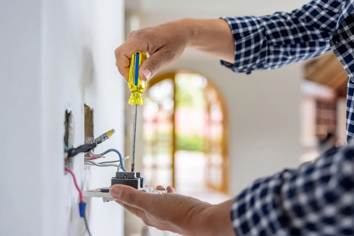 Tech repairing outlet indoors