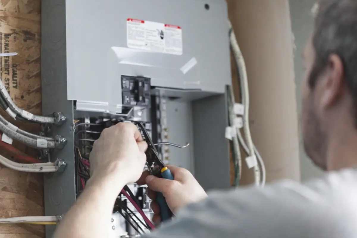 Man in fuse box messing with wires